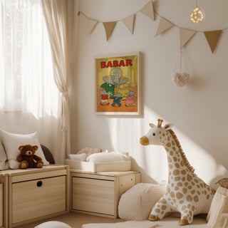 Framed Babar Dancing with Family poster hanging in a cozy nursery decorated with plush toys and soft furnishings.