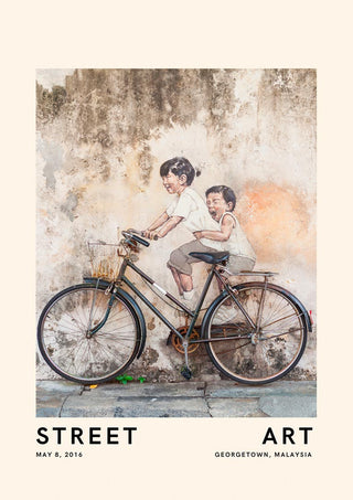 Street art mural of two children riding a bicycle, Georgetown, Malaysia, with real bike attached to wall.