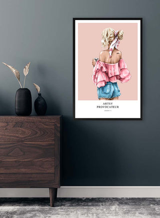 Framed "Artsy Provocateur - Vincent V." print of a woman in pink top, hanging on a modern gray wall above dresser.
