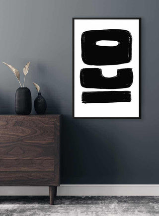 ICO Unique Plakat featuring bold black abstract lettering, framed and hung above a modern wooden dresser.