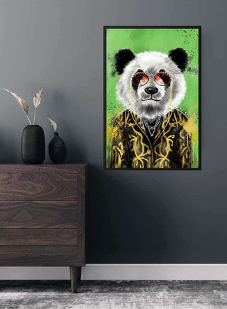 Framed artwork of a panda in a gold jacket and sunglasses, displayed on a dark wall above a wooden cabinet.