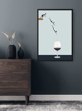 Minimalist art print by Maarten Léon showing figures diving into a wine glass, displayed above a dresser.