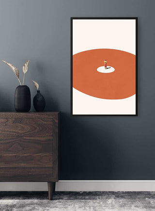 Framed "Confidence" by Maarten Léon on dark wall above wooden dresser with minimalist decor.