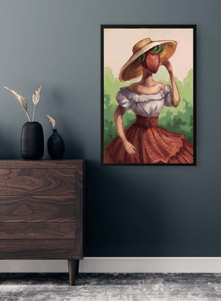 Framed "Strawberry Dreams" art by Kate Aitana featuring a woman with a strawberry head in a rustic outfit.