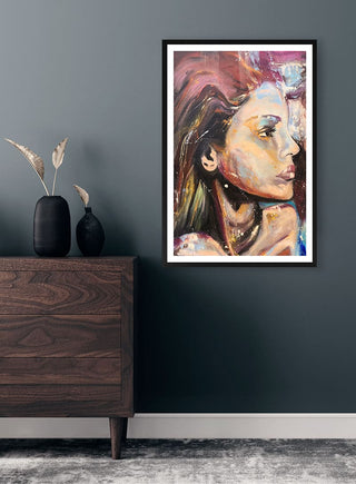 "Dreaming of you" by Martina Karlsson, colorful portrait painting framed on a dark wall above a modern dresser.