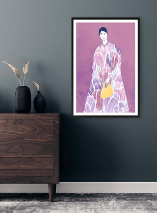 Framed artwork of a woman in patterned attire with a yellow bag, displayed on a dark wall above a dresser.
