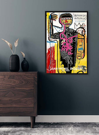 Framed Versus Medici by Jean Michel Basquiat on a dark wall above a wooden dresser with minimalist decor.