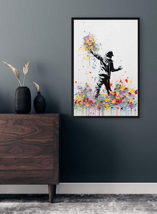 Banksy-inspired Flower Thrower poster on a dark wall above a wooden dresser with decorative vases.