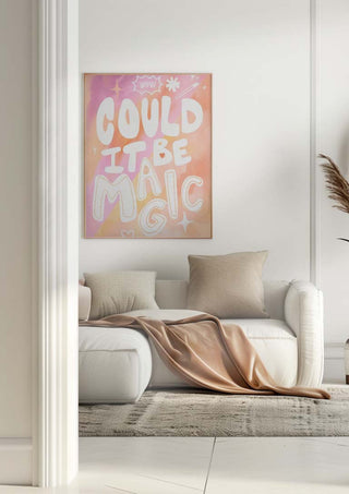 A peach pink "Could it Be Magic" art print hanging above a white sofa in a modern living room.