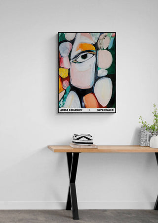 Vibrant Harmony by Martin Zen, abstract face artwork with bold colors, displayed above a modern wooden table.