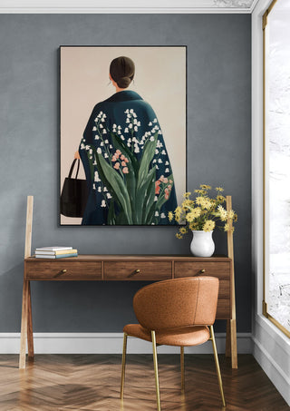 Framed "Take Me Home" by Elara Monet above a wooden desk with flowers and a brown chair in a modern room.