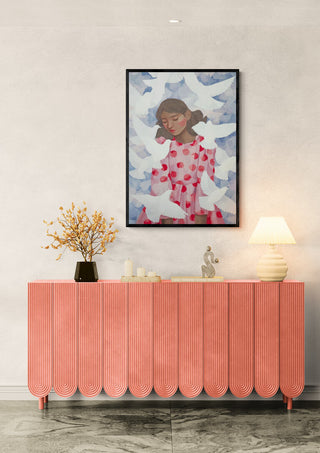 Red Dress Birds by Martina Karlsson hanging above a pink console, with lamp and flowers on top.