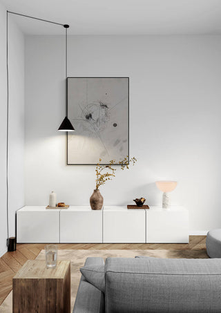 Harmony of Chaos art print displayed above a modern white sideboard in a minimalist living room.