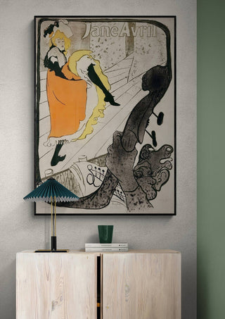 Poster of Jane Avril by Henri de Toulouse-Lautrec displayed above a modern sideboard in a contemporary room.