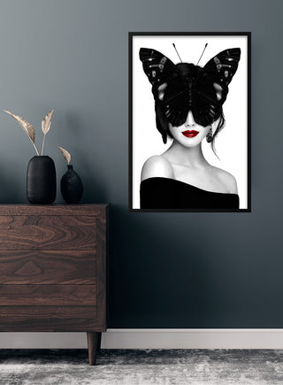 Lady butterfly poster featuring a woman with a butterfly covering her eyes, displayed above a modern wooden dresser.