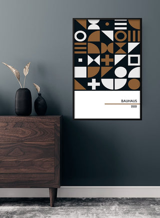 1919 Bauhaus poster #1 with geometric shapes in black, white, and brown on a dark wall above a wooden dresser.