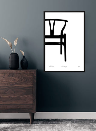 Minimalist poster of Hans Wegner’s Y-chair on a living room wall above a dark wooden dresser.