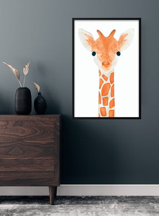 Cute giraffe poster with orange and white design, framed on a dark wall in a children's room setting.