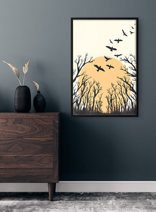 Framed Birds Flying Plakat featuring silhouetted birds over trees with a large sun, displayed on a dark wall.