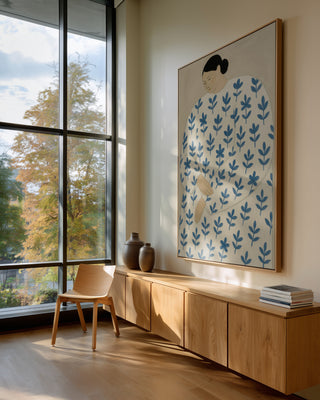 Status Quo by Martina Karlsson artwork on a wall above a wooden sideboard in a modern, sunlit room.