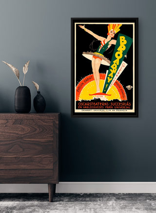 Framed Broadway Vintage Plakat featuring a glamorous dancer, art deco style, displayed above a modern dresser.