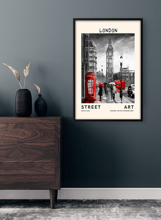 Framed Street Art - London poster featuring red phone booths and Big Ben, hung on a dark wall above a dresser.