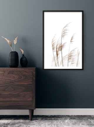 Framed Dry Reeds No. 1 Plakat on wall above dark wood dresser with vases and dried reeds decor.