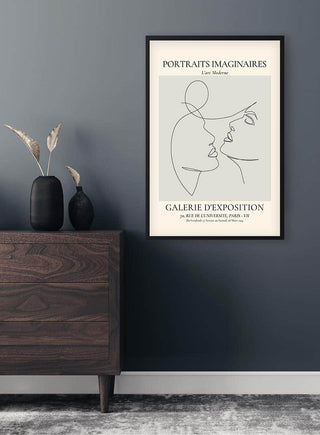 Minimalist line art of two faces about to kiss, titled Portraits Imaginaires Kiss No. 2, framed on a wall.