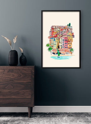 Colorful Venice buildings illustration in a black frame, displayed on a dark wall above a wooden dresser.