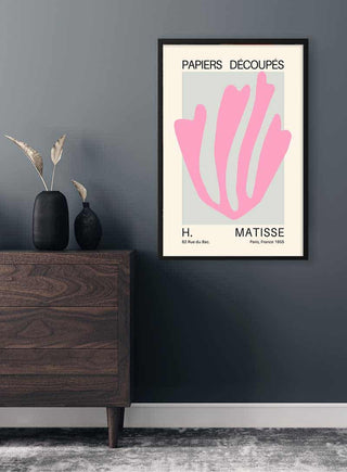 Framed Matisse Inspired Pink Coral Plakat art print on a gray wall above a modern wooden dresser.