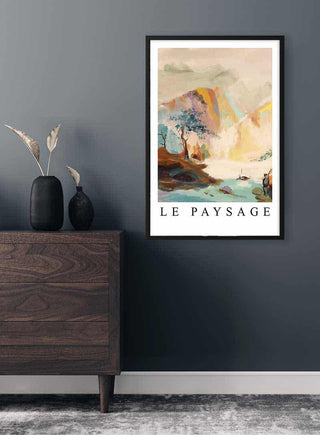 Framed Mountain Landscape Plakat with pastel colors hanging on a dark wall above a wooden dresser.