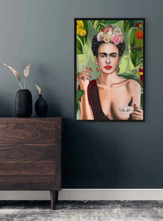 Framed portrait of a woman with flowers in her hair and coffee cup, displayed on a wall above a dresser.