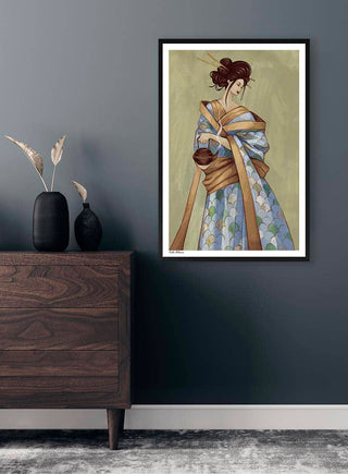 Framed "Becoming Geisha" artwork by Kate Aitana displayed on a gray wall above a wooden dresser.