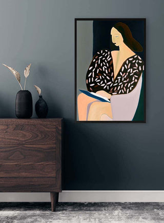 Framed "Think Of Never" by David Wolf on a wall above a dark wood dresser with vases and plants.