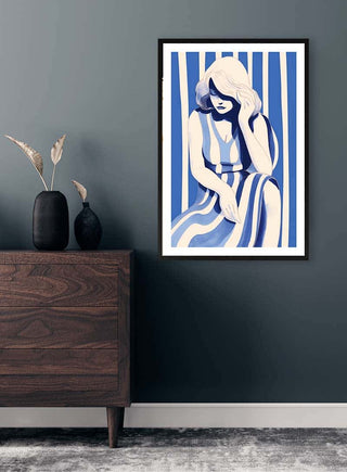 Framed "Blues Dress" artwork by David Wolf on a dark wall above a wooden dresser in a modern room.