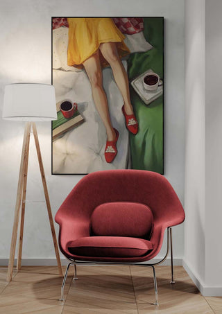 Framed "Coffee Break - Martina Karlsson" art above a red chair and floor lamp in a modern living space.