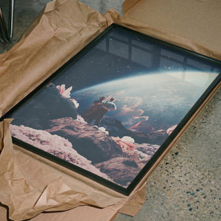 Framed print of "Often Mistaken for Absent" by Frank Moth, featuring a surreal space landscape, in packaging.