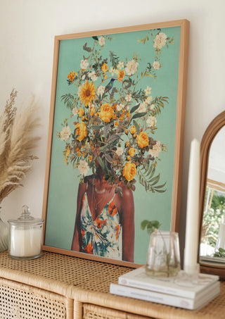 Framed print of "You Loved Me a Thousand Summers Ago" by Frank Moth on a rattan sideboard.