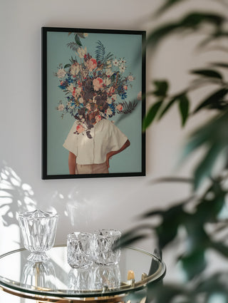 Framed "Thank God It's Spring" by Frank Moth, featuring a floral collage portrait, displayed above glassware.