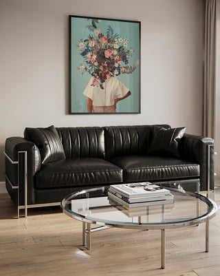 Framed Thank God It's Spring - Frank Moth artwork above a black leather sofa in a modern living room.