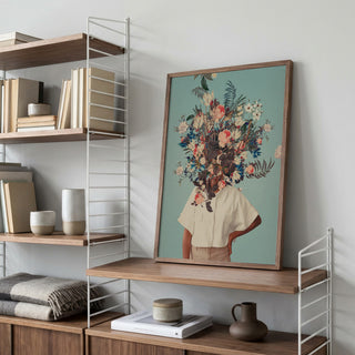 Framed "Thank God It's Spring" by Frank Moth on a wooden shelf, featuring a floral head collage artwork.