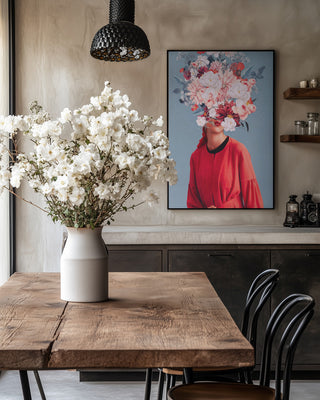 Framed "We Gathered In Spring" by Frank Moth on wall above rustic dining table with white flowers in vase.