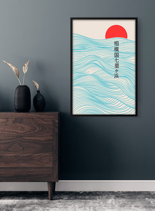 Framed Red Sun Japandi Plakat with blue waves and red sun, hanging above a dark dresser in a modern room.