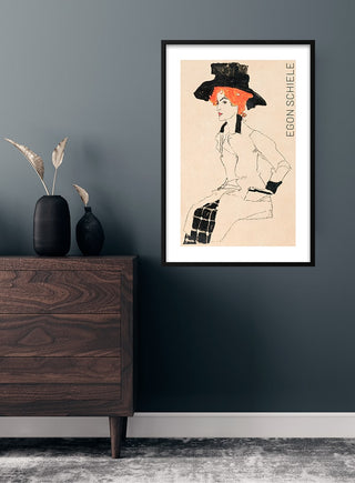Framed Egon Schiele "Portrait of a Woman" (1910) kunstposter displayed above a wooden dresser.