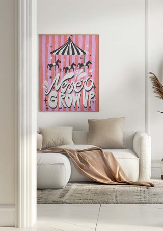 Framed "Never Grow Up" carousel art with pink background hanging above a white sofa in a modern living room.