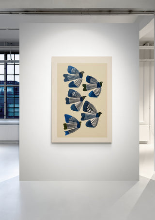 Framed artwork "Birds in Flight" by Branka Kodžoman featuring stylized blue birds displayed on a gallery wall.
