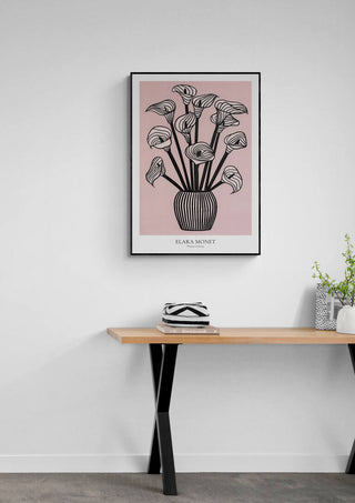 Framed "Whispers of Spring" by Elara Monet featuring abstract flowers in a vase, hung above a modern desk.