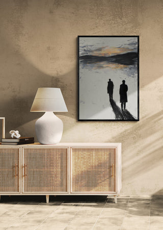 Strolling - Martin Zen artwork of two figures walking, framed above a lamp and sideboard in a modern room.