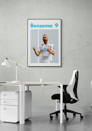 Benzema Real Madrid football poster on a gray wall above a modern office desk and chair.
