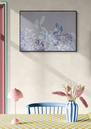Framed Watercolor Pastel Garden Blue artwork on wall above table with vase, flowers, and blue chair.